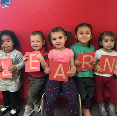 Kids Holding Letters Spelling LEARN