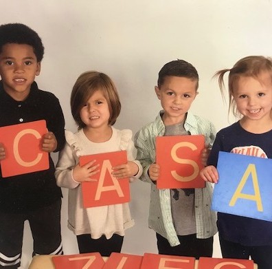 Kids Holding Letters Spelling CASA